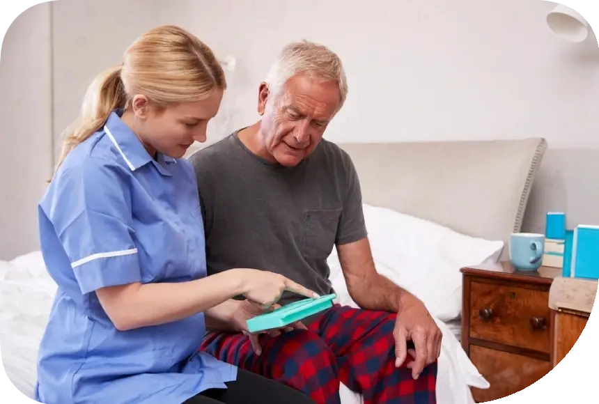 A nurse showing an elderly man something on his tablet.