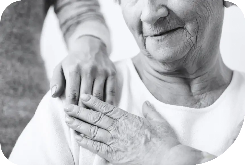 A woman holding her hands over the shoulder of another person.