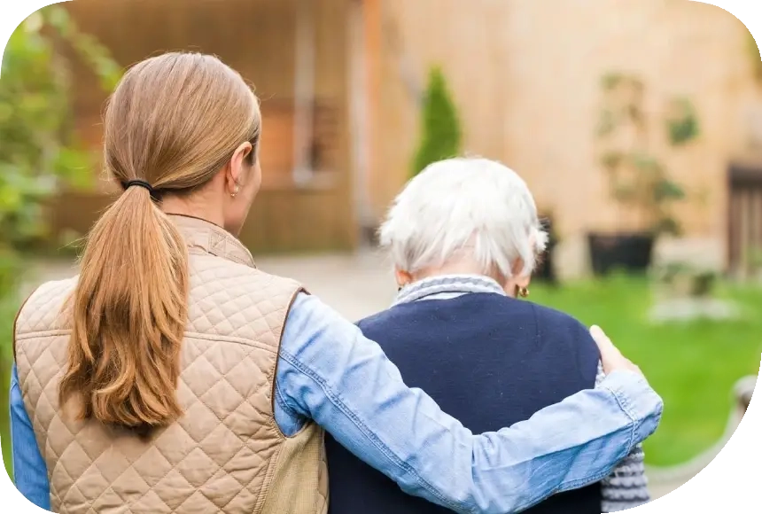 A woman and an older man are holding each other.