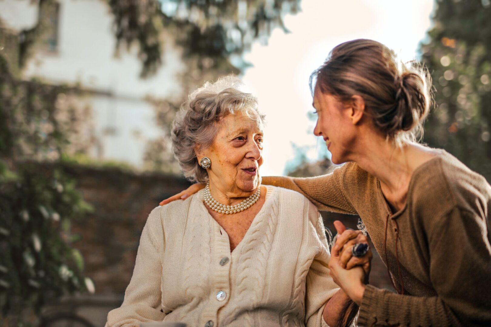 A woman is helping an older person with her hair.